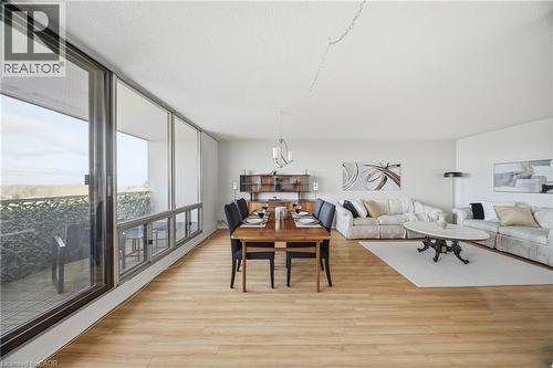 Open-concept living space with expansive wall-to-wall windows, light wood-finish flooring, and a dedicated dining area - 2055 Upper Middle Road Unit# 602, Burlington, ON 