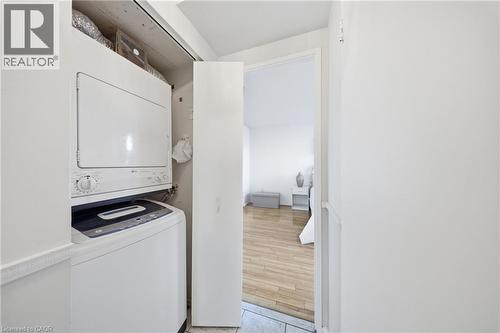 Dedicated laundry closet featuring a stackable washer and dryer unit - 2055 Upper Middle Road Unit# 602, Burlington, ON 