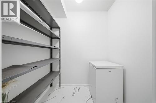 Utility area featuring light-toned walls and high-gloss flooring - 2055 Upper Middle Road Unit# 602, Burlington, ON 