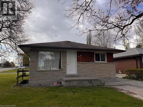Ranch-style exterior featuring a stone facade and red wood-look siding - 105 Marshall Street, Waterloo, ON 