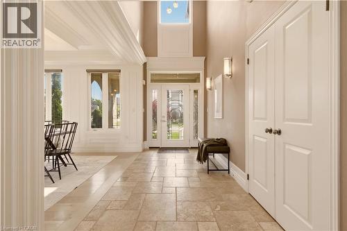 Two-story foyer with transom window and sidelights, stone tile flooring, and double-door entryway - 15 Mcwilliams Court, Cambridge, ON - Indoor Photo Showing Other Room