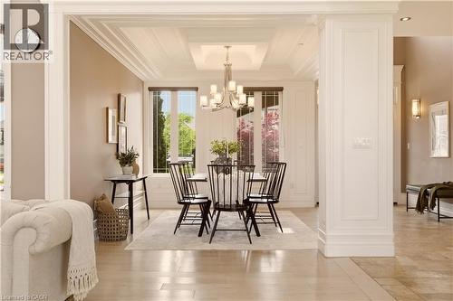 Formal dining area featuring extensive crown molding and a coffered ceiling with a chandelier - 15 Mcwilliams Court, Cambridge, ON - Indoor Photo Showing Dining Room