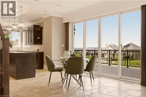 Expansive sliding glass doors opening to an outdoor patio with a glass railing - 15 Mcwilliams Court, Cambridge, ON - Indoor Photo Showing Dining Room
