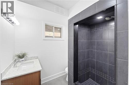 Tiled shower enclosure featuring a recessed light and shower head - 968 Main Street E, Hamilton, ON 