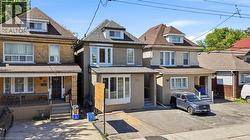 Stucco exterior featuring a prominent bay window and white trim - 