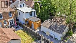 Two-story residential structure with a light-colored exterior and a flat roof - 