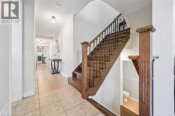 Hardwood staircase with wrought iron balusters and a substantial newel post - 