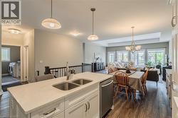 Kitchen island with a double stainless steel sink and light-colored countertop - 