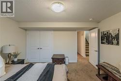 Carpeted interior space featuring neutral wall paint, white trim, and a flush mount ceiling light fixture - 
