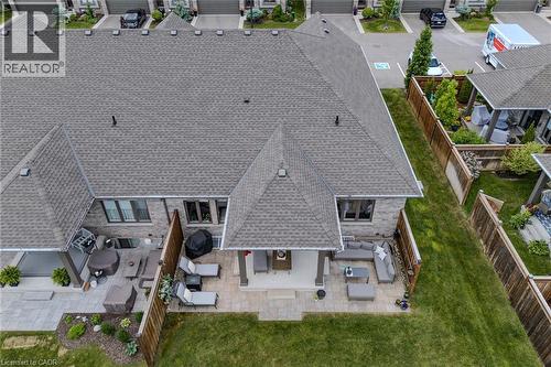 Expansive backyard featuring a manicured lawn and two distinct patio areas - 15 Winterberry Lane, Waterford, ON 