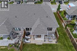 Expansive backyard featuring a manicured lawn and two distinct patio areas - 