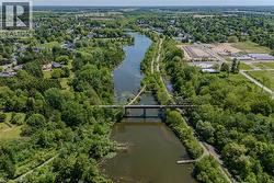 Expansive aerial perspective showcasing a river, bridge, and surrounding green spaces - 