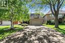 Brick exterior with dormer window, an attached garage, and a patterned driveway - 85 Citation Crescent, Ancaster, ON 