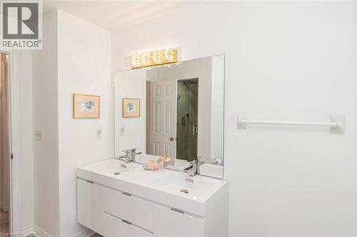 Contemporary bathroom featuring a double vanity with integrated sinks and chrome fixtures - 85 Citation Crescent, Ancaster, ON 