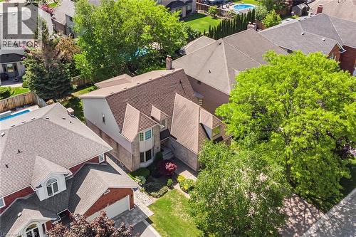Two-story residential architecture featuring a stone and stucco façade, prominent bay window, and gabled rooflines - 85 Citation Crescent, Ancaster, ON 