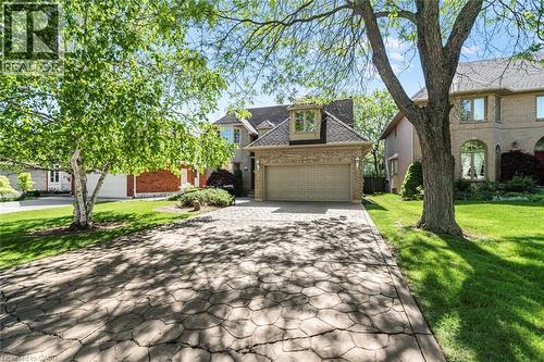 Two-story brick exterior with an attached two-car garage - 85 Citation Crescent, Ancaster, ON 