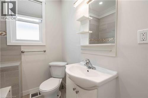 Modern bathroom featuring a white vanity with an integrated sink and chrome faucet - 204 Glow Avenue Unit# Upper, Hamilton, ON 