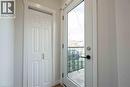 Full-lite exterior door with black hardware, flanked by a paneled bi-fold door - 204 Glow Avenue Unit# Upper, Hamilton, ON 