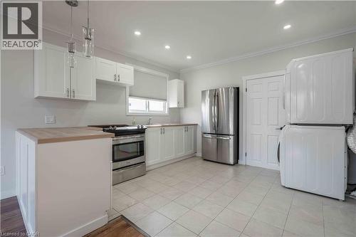 Kitchen featuring white cabinetry, light wood-finish countertops, stainless steel appliances, and recessed lighting - 204 Glow Avenue Unit# Upper, Hamilton, ON 