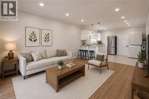 Open-concept living space featuring wood-finish flooring, recessed lighting, and a kitchen with a breakfast bar and stainless steel appliances - 204 Glow Avenue Unit# Upper, Hamilton, ON 