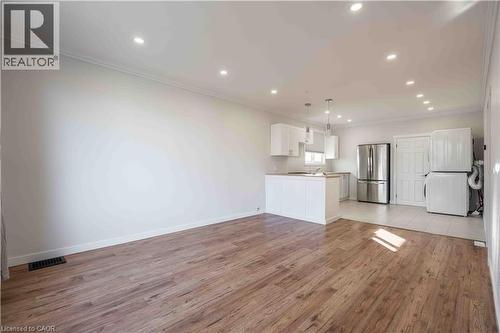 Open concept living area featuring wood-finish flooring - 204 Glow Avenue Unit# Upper, Hamilton, ON 