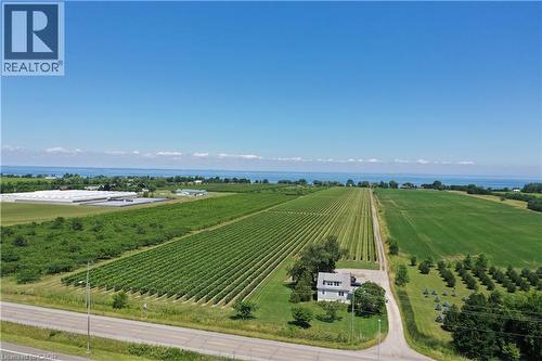 Expansive rural property featuring a two-story home, cultivated fields, and distant water - 3705 Service Road N, Beamsville, ON 