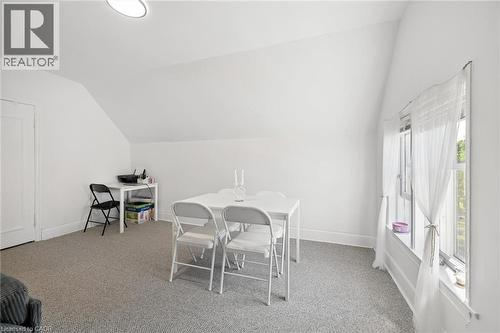 Carpeted room with sloped ceilings and a window featuring white trim - 149 Young Street, Kitchener, ON - Indoor