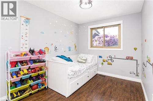 Bright room with wood-finish flooring, a single window, and a flush-mount ceiling light fixture - 103 Mcanulty Boulevard Unit# Upper, Hamilton, ON 