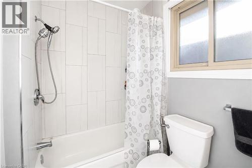 Full-size bathtub with subway tile surround and chrome fixtures - 103 Mcanulty Boulevard Unit# Upper, Hamilton, ON 