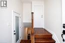 Stairway landing featuring wood-finish flooring, white walls, and a wood newel post - 103 Mcanulty Boulevard Unit# Upper, Hamilton, ON 