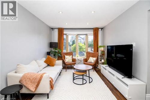 Living area featuring a bay window, recessed lighting, light gray wall paint, and dark wood-finish flooring - 103 Mcanulty Boulevard Unit# Upper, Hamilton, ON 