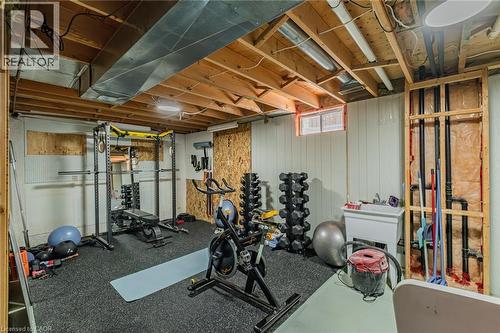 Finished basement space featuring exposed wood joists and utility ducts - 141 Lynndale Road, Simcoe, ON 