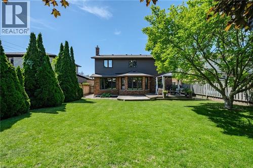 Expansive green lawn with mature perimeter trees and a fenced boundary - 141 Lynndale Road, Simcoe, ON 