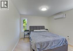 Bright interior space featuring light-toned walls and wood-finish flooring - 