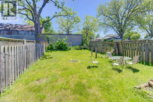 Expansive grassy yard area with mature trees and wood fencing - 11 Davidson Street, Cambridge, ON 