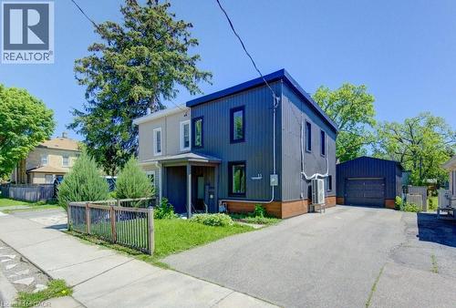 Modern two-story residence featuring a dark corrugated metal facade and contrasting light-toned siding - 11 Davidson Street, Cambridge, ON 