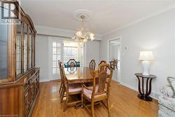 Hardwood flooring extending throughout, crown molding, and a decorative ceiling medallion - 