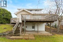 Raised deck with wood railing and staircase - 