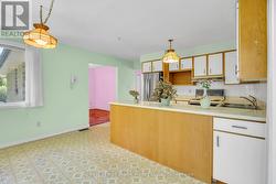 Kitchen with 3 large windows and walkout to deck - 