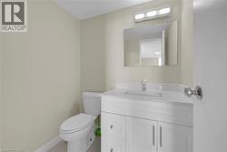 Bathroom vanity featuring a white cabinet with brushed nickel hardware, integrated sink, and a chrome faucet - 