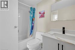 Bathroom featuring a white vanity with a single basin, a black single-lever faucet, and a large wall-mounted mirror - 
