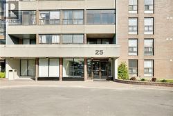 Brick facade multi-story building featuring a prominent main entrance with glass doors - 