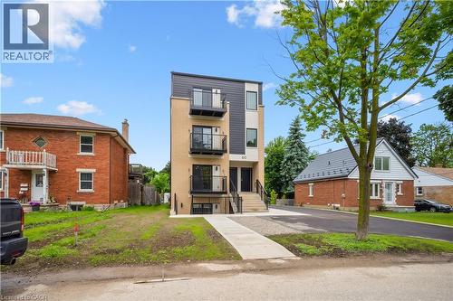 Modern multi-level building featuring a combination of brick and dark panel siding - 60 Arlington Boulevard Unit# 3, Kitchener, ON 