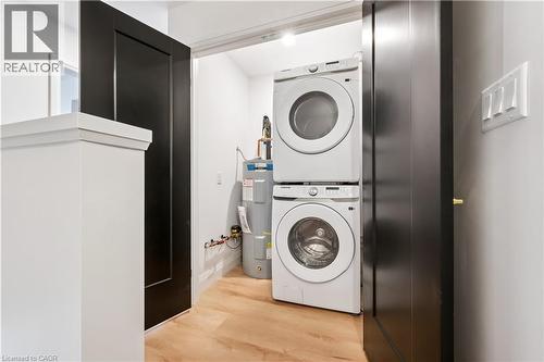 Dedicated laundry area with stacked washer and dryer units - 60 Arlington Boulevard Unit# 3, Kitchener, ON 