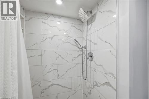 Shower with large format marble-look tile, rainfall showerhead, and handheld shower sprayer - 18 Ipswich Place, Hamilton, ON 