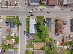 Aerial perspective showcasing an urban block with multiple structures and parking areas - 