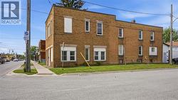 Two-story brick building with multiple windows - 