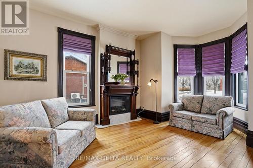 Parlour with bay window, electric fireplace. - 132 High Street, Champlain, ON 