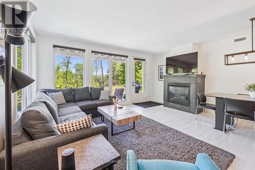 Living area with gas fireplace - walkout to patio - 101 - 1 Tree Tops Lane, Huntsville (Chaffey), ON 