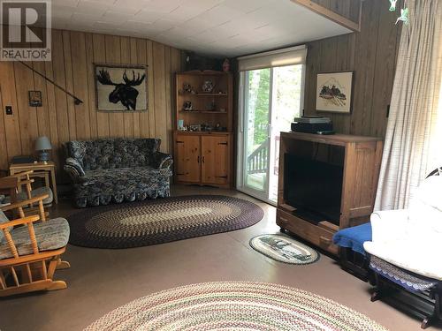 **Living Room Walks Out To Large Sundeck** - 1160 Sunset Strip Lane, Frontenac, ON - Indoor Photo Showing Other Room With Fireplace
